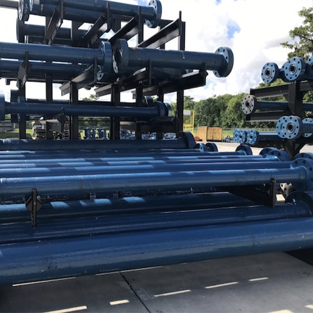 Stacked studded flanges and test caps used in high-pressure well testing operations